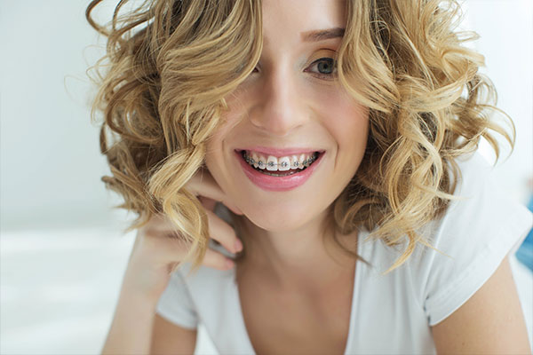 Tooth Extraction | Dr. John M. Cherry, Jr., DMD - Brandon Dentist | woman with braces smiling after tooth extraction