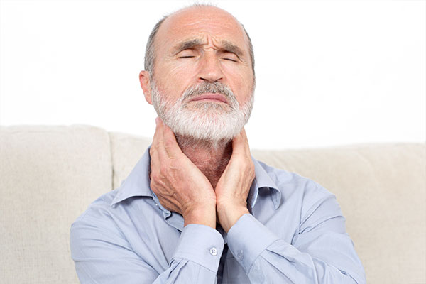 Root Canals | Dr. John M. Cherry, Jr., DMD - Brandon Dentist | older man in pain rubbing neck