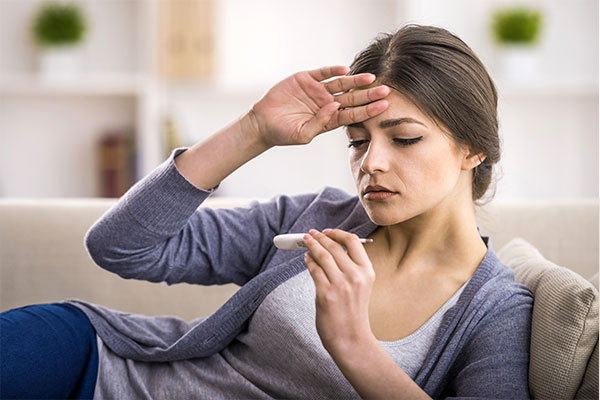 Tooth Extraction | Dr. John M. Cherry, Jr., DMD - Brandon Dentist | woman taking temperature