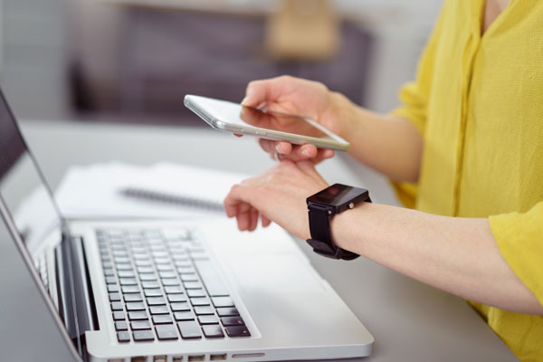 Teeth Whitening | Dr. John M. Cherry, Jr., DMD - Brandon Dentist | woman looking at cellphone laptop and smart watch
