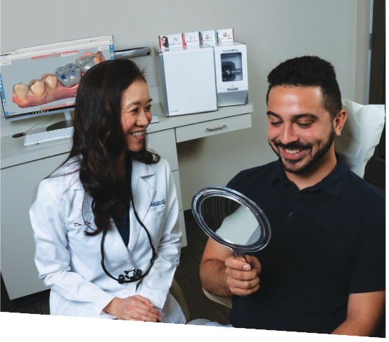 Same-Visit Crowns | Dr. John M. Cherry, Jr., DMD - Brandon Dentist | dentist and patient looking at smile in mirror